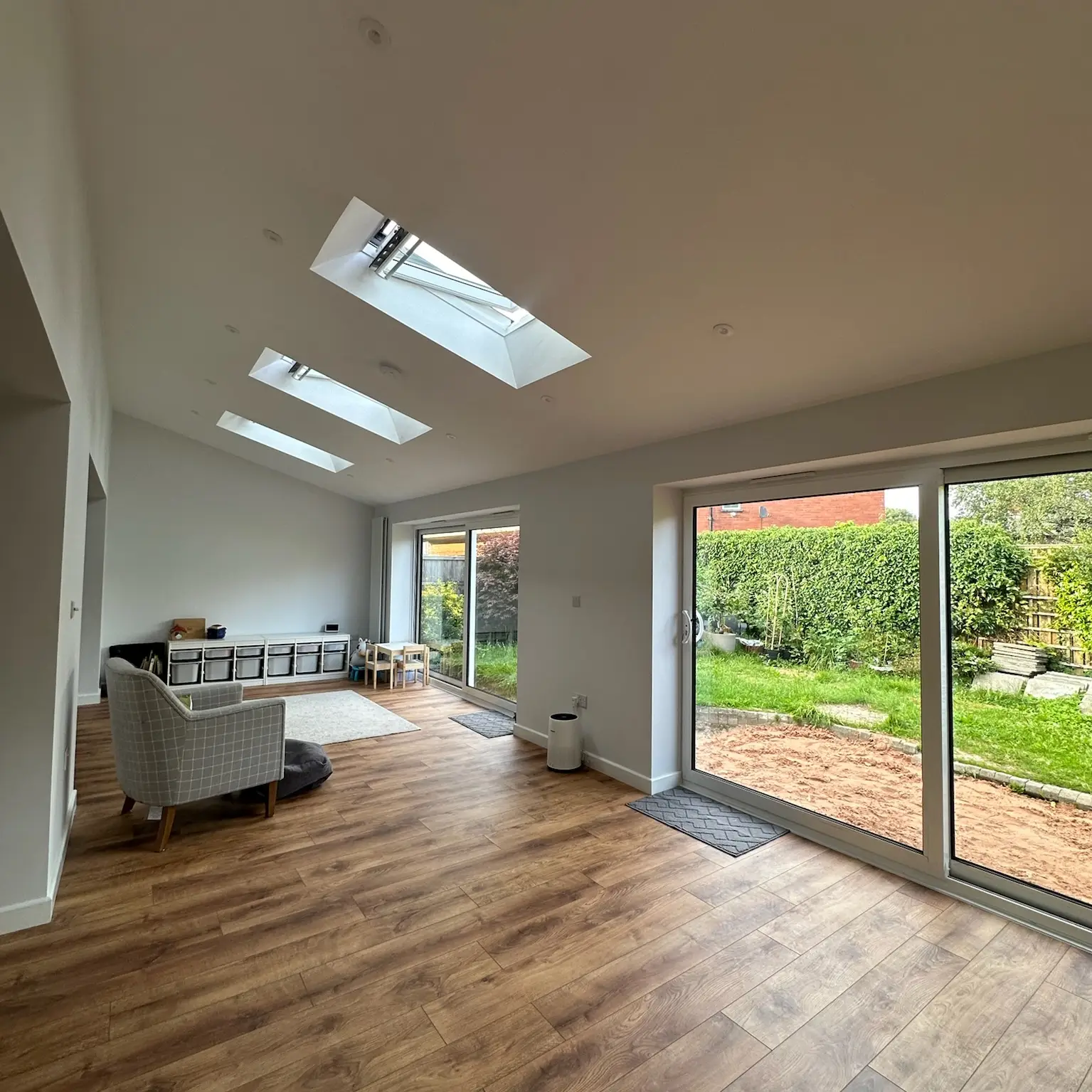 Garage converted into a family room with sliding doors onto the garden